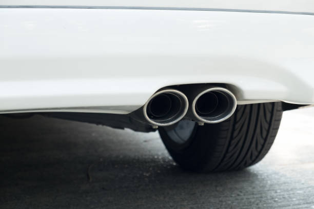 istock Chrome exhaust pipe of white powerful sport car bumper 647012426