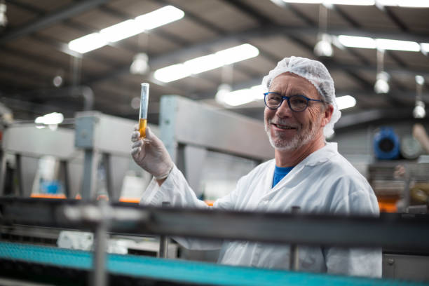 istock Factory engineers holding a sample of drink 647015270