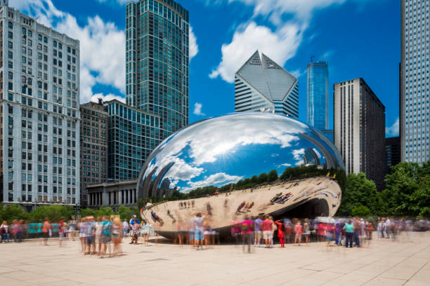 Tourist around the Cloud Gate ("The Beam") at the Millennium Park in Chicago, Illinois Chicago, Illinois, USA - July 3, 2014: Tourists around the Cloud Gate ("The Beam") at the Millennium Park in Chicago, Illinois millennium park chicago stock pictures, royalty-free photos & images