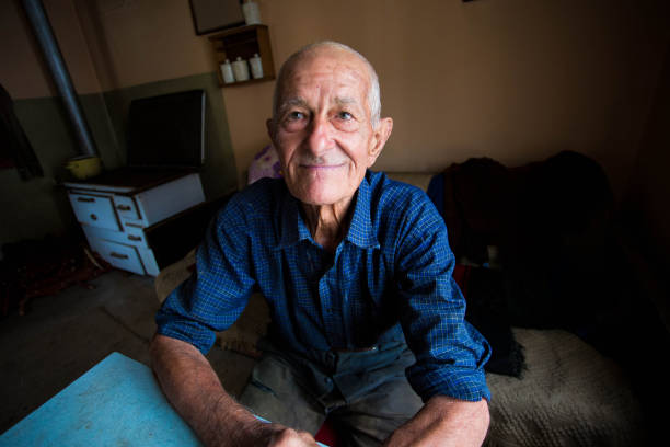 istock Old smiling grandfather looking at the camera 647030246