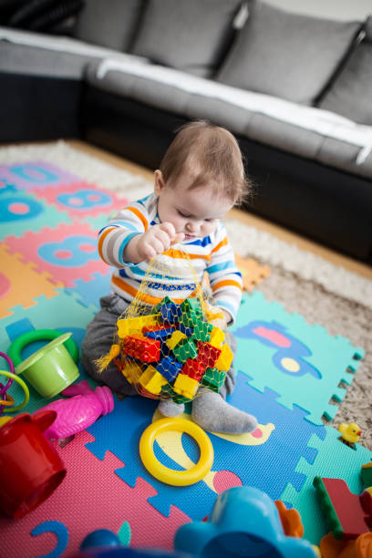istock Caucasian baby boy playing with toys 647035852