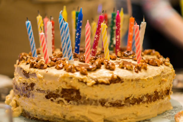 istock Birthday cake with nuts and candles background 647035940