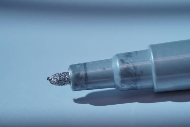 The calligraphy training. Fountain pen in ink-stained hands