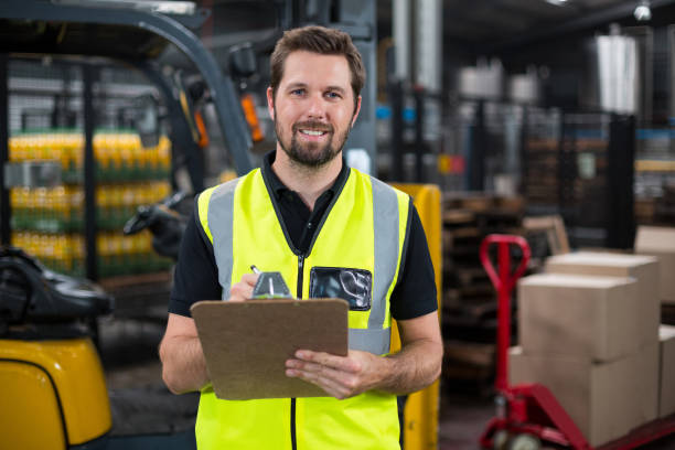 istock Factory worker writing on clipboard in factory 647040528