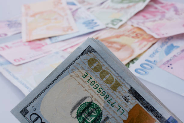 istock American dollar banknotes and Turksh Lira banknotes side by side 647047506
