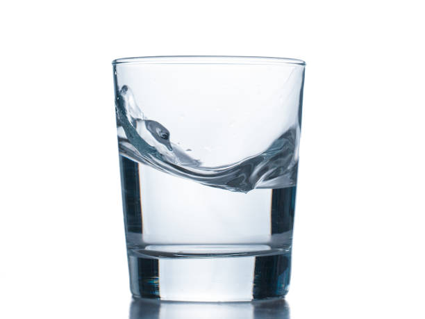istock water splashing from glass isolated on white background 647047532