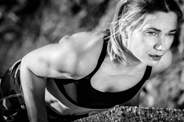 istock Young woman on cross training doing pushups 647051070