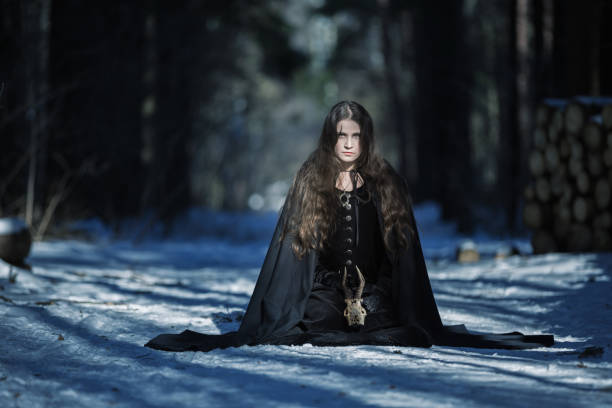 istock The witch with a skull in the forest 647053480