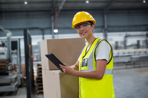 istock Portrait of smiling female worker using a digital tablet 647056874