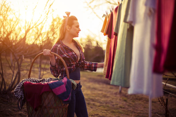istock Beautiful lady with a basket filed with loundry 647056960