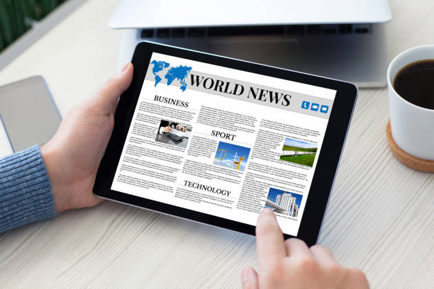 istock male hands holding tablet computer world news table notebook phone 647060370