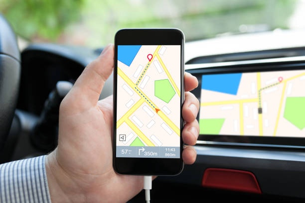istock man hand in car holding phone with navigation map 647060500