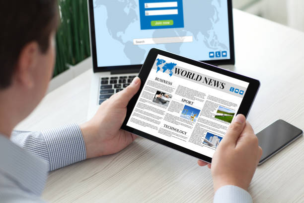 istock man holding tablet computer world news with notebook phone 647061274