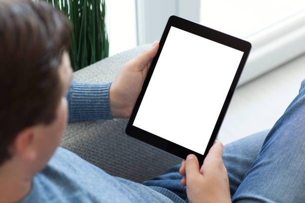 istock man in jeans sitting and holding tablet computer isolated screen 647061498