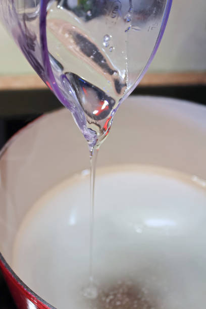 istock Pouring Thick Liquid Sugar from a Measuring Cup 647067138