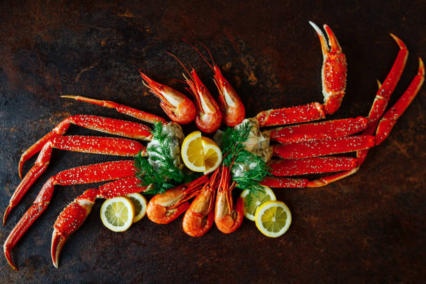istock Crab claws and shrimp with lemon and dill top view 647074464