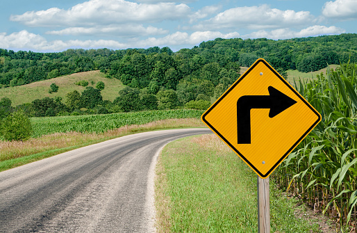 A sign warns of a sharp right turn on a country road in southern Wisconsin.