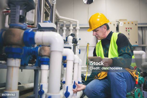 Technician Checking The System Stock Photo - Download Image Now - Plumber, Water, Industry