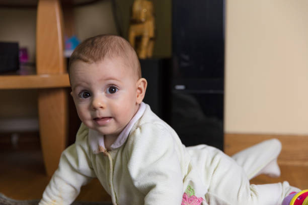Little baby girl crawling and playing on the floor.Little baby girl crawling and playing on the floor.