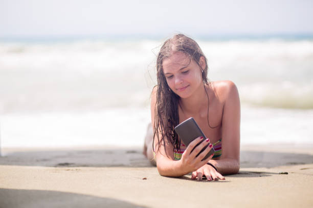 istock Pretty girl taking selfie on a beach 647087482