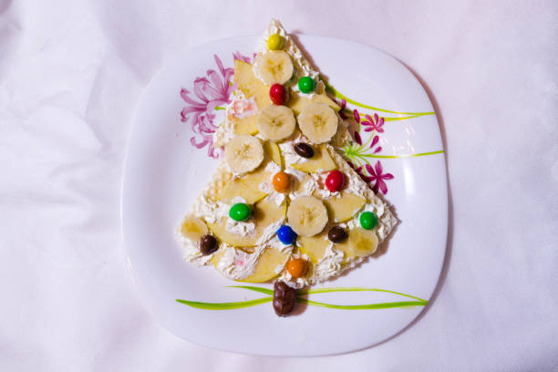 istock Children dessert with bananas and candy. 647087658