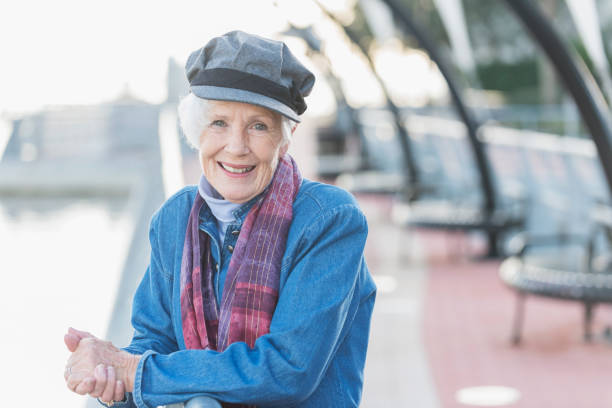 istock Stylish senior woman leaning against railing 647089734