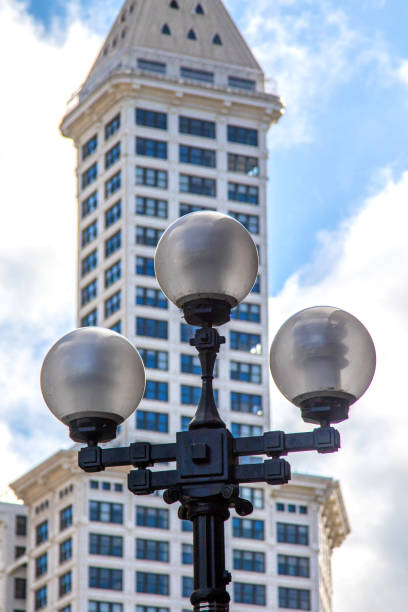 Old fashioned street lamp, with Smith Tower in the background. Seattle, WA, USA.