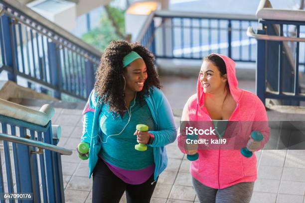 Two Young Women Exercising Powerwalking Up Stairs Stock Photo - Download Image Now - Exercising, Overweight, Walking