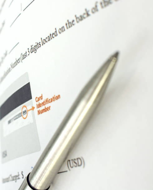 istock Credit Card authorization form, filled out, with pen 647090848