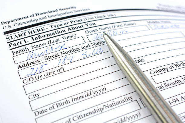 istock USA Immigration form with pen this -is fictitious data 647093808