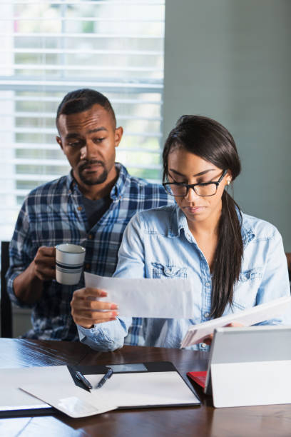istock Young black couple, woman on computer paying bills 647095904