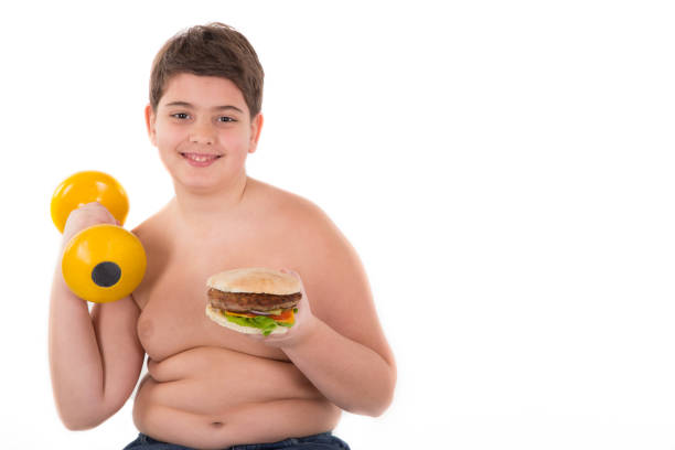 prawo decyzja - overweight child eating hamburger zdjęcia i obrazy z banku zdjęć