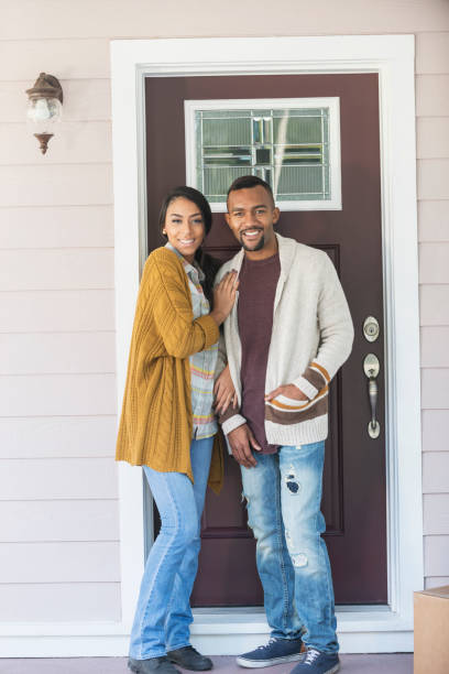 istock Young mixed race couple standing by front door 647096112