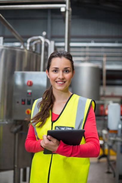 istock Female factory worker holding digital tablet 647096264
