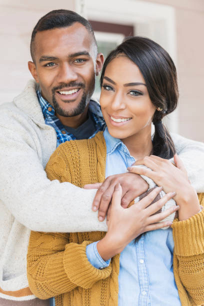 istock Affectionate young mixed race couple on front porch 647096348