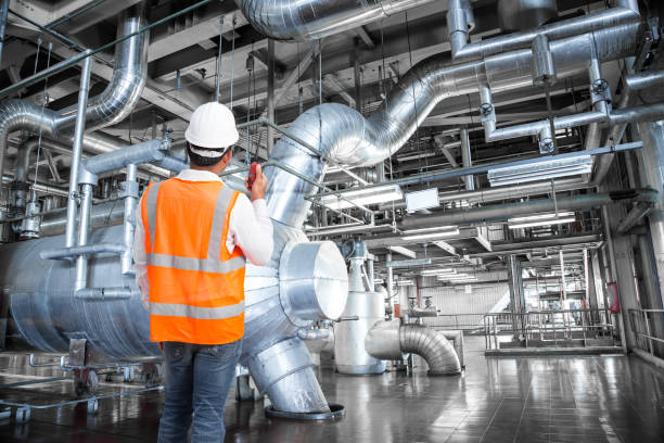 istock Engineer working in thermal power plant with talking on radio 647096732