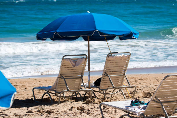 istock Two beach chairs and umbrella in front of the ocean 647099544