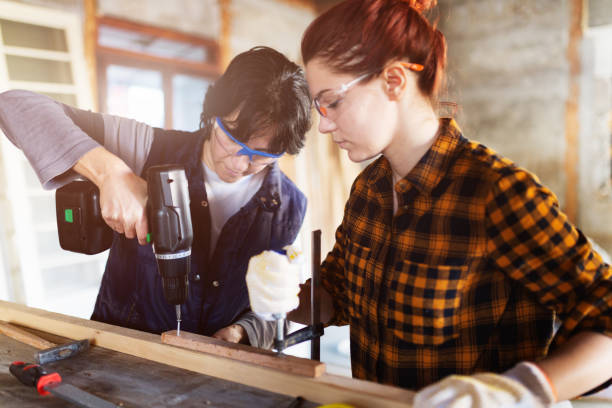 istock Females carpenters  work together 647099674