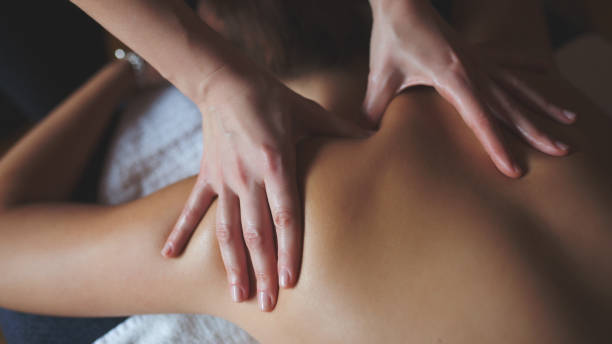 マッサージセラピー - massaging massage therapist rear view human hand ストックフォトと画像