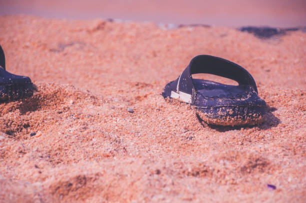 istock slippers on tropical beach in summer film color effect. 647106960
