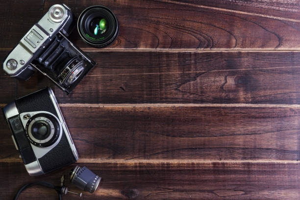 istock Top view of vintage old camera on wooden table 647122808