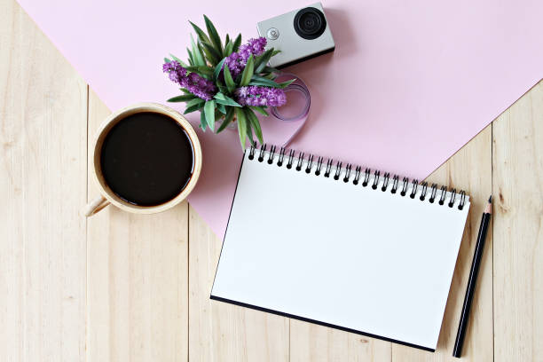 istock Flat lay style of office workspace desk with blank notebook paper, cup of coffee 647129942