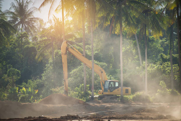 istock Excavator digging and removing earth .Digger machine adjusting ground level in construction site. 647130162
