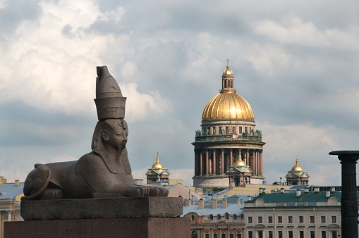 Ancient Egyptian sphinx of pharaoh Amenhotep III with the Saint Isaac's Cathedral in the background. Universitetskaya Embankment in Saint Petersburg