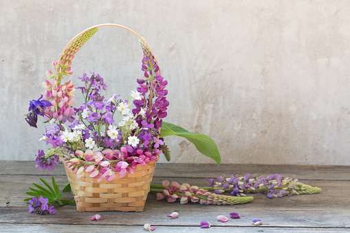 still life with summer flowers in basket