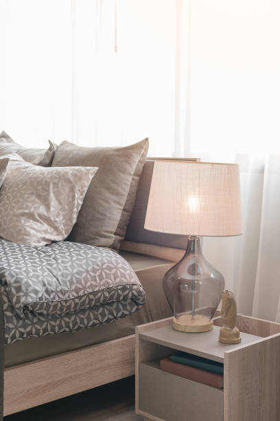 istock classic lamp style with alarm clock on table side in cozy bedroom 647140476