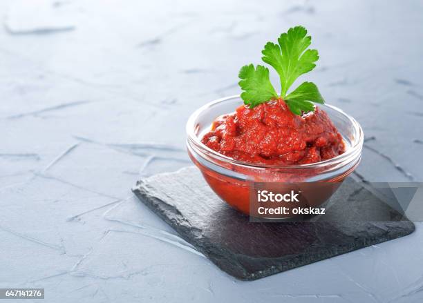 Tomato Paste In A Glass Bowl On A Black Stone Stock Photo - Download Image Now - Condiment, Crockery, Cultures