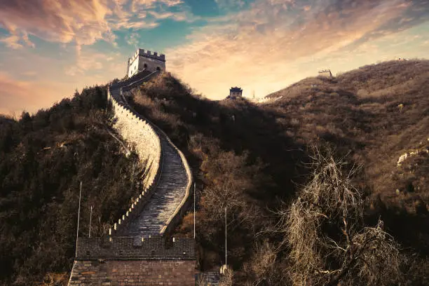 Great Wall of China with path and watchtower under sunset sky in Beijing, China