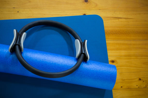istock Pilates ring and exercise mat kept on wooden floor 647148872