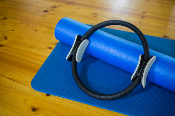 istock Pilates ring and exercise mat kept on wooden floor 647148992